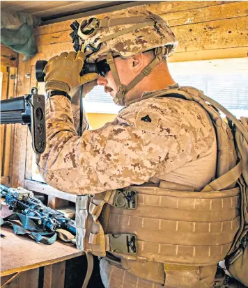  ??  ?? A marine on guard at the US embassy in Baghdad. One senator has warned that Donald Trump could target Iranian refineries next