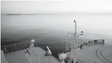  ??  ?? A Finnish icebreaker sails past the U.S. island of Little Diomede, left, and behind it, the Russian island of Big Diomede, separated by the Internatio­nal Date Line on the Bering Strait.