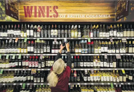  ?? ARLEN REDEKOP ?? Angela Ruffer works in the wine section at Save-On-Foods in Surrey, Monday. As of Nov. 1, 2019, U.S. wines will join those from B.C. under the new USMCA deal. “The problem for us is that there is only so much shelf space,” says Miles Prodan, president and CEO of the B.C. Wine Institute.