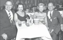  ?? PHOTO COURTESY JUDY HIMES ?? Rosslynn Grove’s owner Ross Bullas, left, and his wife Helen share a table and “soft drinks” with band leader Merv Himes and his wife Erna away from the bandstand in the mid-1950s.