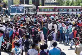  ?? — PTI ?? Migrant workers wait to board buses to their native places at Ghazipur on Delhi-UP border on Saturday.