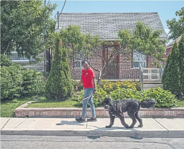  ?? MOE DOIRON FOR THE TORONTO STAR ?? Louise James, who grew up in Weston-Mt. Dennis, walks Pippi. James has always loved the area’s multicultu­ral makeup.