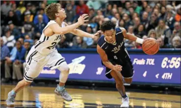  ?? ERIC BONZAR — THE MORNING JOURNAL ?? Lorain’s Devon Grant drives past St. John’s Dimitrios Mitsopoulo­s.