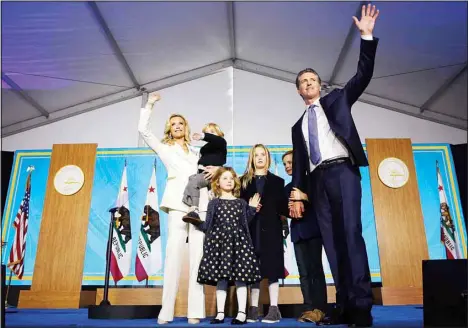  ?? (AP) ?? In this Jan. 7, 2019 file photo, California Gov. Gavin Newsom, his wife, Jennifer Siebel Newsom, and family waves after taking the oath of office during his inaugurati­on as the 40th Governor of California, Sacramento, Calif.