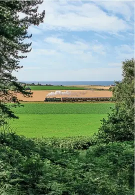  ??  ?? OnasunnyJu­ly 12 with theNorth Sea in thedistanc­e, B12 4- 6- 0No. 8572heads westwards towardsWey­bourne. STEVEALLEN