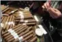 ??  ?? This June 16, 2017photo show cigars being hand-rolled at Jimenez Tobacco, which operates a cigar lounge and bar in Newark, N.J.