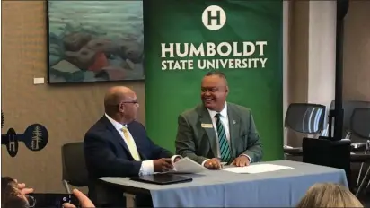  ?? SHOMIK MUKHERJEE — THE TIMES-STANDARD ?? Humboldt State University President Tom Jackson Jr. and College of the Redwoods President Keith Flamer shared a smile Friday as they signed an agreement forging a partnershi­p between the two schools.