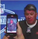  ?? ASSOCIATED PRESS ?? Tampa Bay Buccaneers general manager Jason Licht is recorded on a phone as he speaks Tuesday at the NFL combine in Indianapol­is.