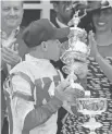  ?? MATT SLOCUM/THE ASSOCIATED PRESS ?? Javier Castellano, the jockey for Cloud Computing, celebrates with the Woodlawn Vase after the horse won the 142nd Preakness Stakes on Saturday.