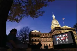  ?? DAVID GOLDMAN — THE ASSOCIATED PRESS FILE ?? The phrase “Count Every Vote” is displayed on a large screen organized by an advocacy group in front of the State Capitol while election results in several states had yet to be finalized in Lansing, Mich.