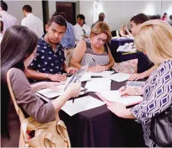  ??  ?? MIAMI LAKES: People fill out job applicatio­ns at a job fair in Miami Lakes, Fla. Tepid income growth and shrinking opportunit­ies for blue-collar workers have kept many Americans anxious about jobs and the economy, seven years after the Great Recession ended. —AP