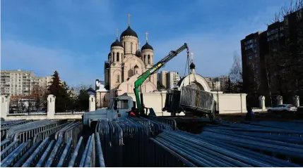  ?? AFP PHOTO ?? FUNERAL
Workers unload metal fencing in front of a church in Moscow on Thursday, Feb. 29, 2024, where a funeral ceremony for late Russian opposition leader Alexei Navalny is set to take place on Friday, March 1.