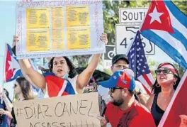  ?? LIZZIE HEINTZ/ORLANDO SENTINEL ?? Protesters gather and chant on Semoran Boulevard in Orlando on Thursday to raise awareness for the political unrest currently taking place in Cuba. They demanded justice and freedom for Cubans who have been allegedly targeted by police for speaking out against the country’s communist regime, which has been in place for 62 years.