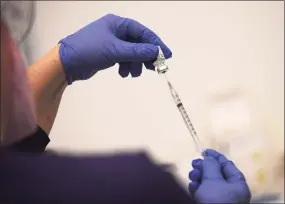  ?? Tyler Sizemore / Hearst Connecticu­t Media file photo ?? Carly Plymel RN prepares a dose of the Pfizer COVID-19 vaccine at a vaccinatio­n clinic in Stamford on April 6.