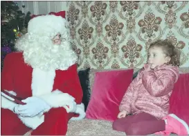  ?? (Pic: John Ahern) ?? HMMM! 4-year-old, Aimee Zuzelska from Fermoy, who had an interestin­g exchange with Santa when they met at last Friday evening’s Christmas market in Fermoy.