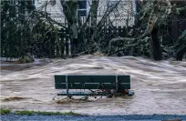  ?? PHOTO: REUTERS ?? Water seat . . . The flooded Maitai River in Nelson swamps a park bench.