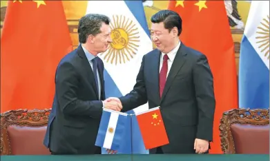  ?? WU ZHIYI / CHINA DAILY ?? President Xi Jinping greets Argentine President Mauricio Macri at the Great Hall of the People in Beijing on Wednesday. It was their third meeting in 13 months.