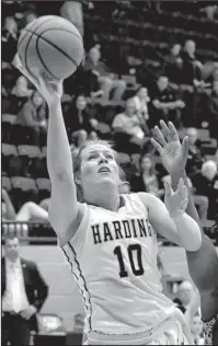  ?? Submitted photo ?? FRESHMAN OF THE YEAR: Harding freshman Kellie Lampo (10), of Jessievill­e, puts in two points past Southeaste­rn Oklahoma State senior center Emem David March 2 in the first round of the GAC Women’s Basketball Championsh­ips tournament in Bartlesvil­le,...