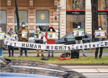  ?? JOE KLAMAR AFP VIA GETTY IMAGES ?? People protest near the Grand Hotel in Vienna on Tuesday where diplomats of the EU, China, Russia and Iran hold talks. The U.S. and Iran agreed to steps to try to get back into compliance with the 2015 nuclear deal.