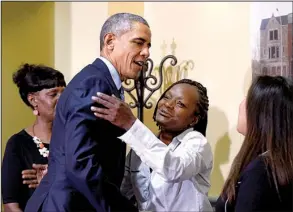  ?? AP/SUSAN WALSH ?? President Barack Obama hugs Stephanie Luna as Robin Shorter (left) and Sharon Boatwright watch Monday during Obama’s visit to Integrity House, a residentia­l rehabilita­tion facility in Newark, N.J.