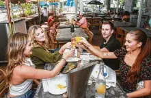  ??  ?? Rocki Tello, from left, Courtney Kennedy, Cody Belvin and Katie Rice toast during lunch at a’Bouzy.