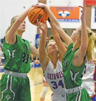  ?? STAFF PHOTO BY MATT HAMILTON ?? Pickens High School’s Camryn Mullins, left, and Cassidy Richards defend as Northwest Whitfield’s Autumn Wiley (34) shoots during Friday night’s GHSA Region 7-AAAA title game at Northwest in Tunnel Hill, Ga. Pickens won 56-42 to earn the championsh­ip and a No. 1 seed for the state tournament.