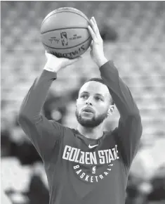  ?? Marcio Jose Sanchez/Associated Press ?? ■ Golden State Warriors’ Stephen Curry shoots during warmups before Game 1 of an NBA second-round playoff series against the New Orleans Pelicans on Saturday in Oakland, Calif.