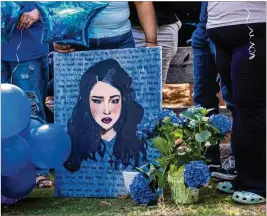  ?? ARVIN TEMKAR/ARVIN.TEMKAR@AJC.COM ?? A painting of 15-year-old Mia Dieguez is seen before a balloon release at Brook Run Park in Dunwoody on Wednesday. The Dunwoody High School student died after a medical emergency Monday.