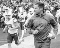  ?? KEITH SRAKOCIC/AP ?? UM coach Manny Diaz takes the field with the team against Pittsburgh on Saturday.