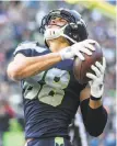  ?? Grant Hindsley / SeattlePI.com ?? Left, most Texans knelt during the anthem in protest of comments by owner Bob McNair. Above, Seattle tight end Jimmy Graham scored two second-half TDs.