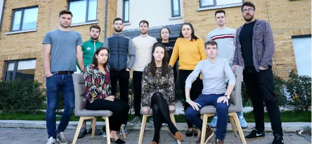  ??  ?? RELIEVED: Young tenants (standing, from left): John Brown, Proinsias O Gallchoir, Conor Hegarty, Niall McKenna, Aine McCaul, Aoife Murphy, Gordon Glynn and Emmet Bracken, (seated, from left): Niamh Colleran, Karen Carty and Cathal Keogh, outside their homes in Hampton Wood Square in Finglas. Photo: Frank McGrath