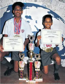  ??  ?? Aaryan and Rudhra Poorun show off their medals, trophies and certificat­es