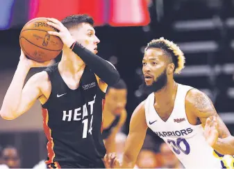  ?? Rich Pedroncell­i / Associated Press ?? Warriors guard Ky Bowman (right) defends Miami guard Tyler Herro in the summer league, in which he is focusing on improving his reading of the game as a point guard.