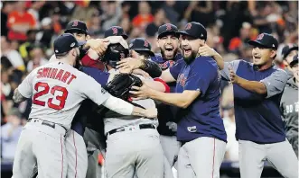  ?? DAVID J. PHILLIP/THE ASSOCIATED PRESS ?? The Boston Red Sox celebrate after winning Game 5 of the American League Championsh­ip Series Thursday with a 4-1 win over the Astros in Houston to advance to the World Series.