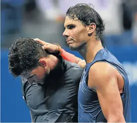  ?? /AFP ?? Friendly foes: Spain’s Rafael Nadal consoles Austria’s Dominic Thiem after their marathon quarterfin­al that ended after 2am New York time on Wednesday.