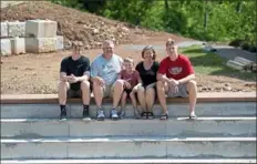  ?? Pam Panchak/Post-Gazette photos ?? Trevor, left, Eric, Maddox, Stacy and Payton Faulkner sit on what will be the top step of their new pool in Kilbuck.