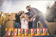  ?? NATHAN BURTON/Taos News ?? Volunteers unload donations in preparatio­n for the annual St. James Episcopal Church Thanksgivi­ng food drive on Thursday (Nov. 18).