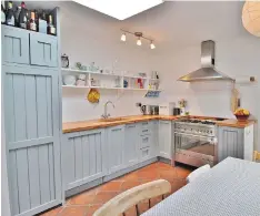  ??  ?? The kitchen with terracotta tiled floor is in the rear extension at No61 West Road (left)