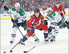  ?? [MANUEL BALCE CENETA/THE ASSOCIATED PRESS] ?? Washington Capitals right wing T.J. Oshie, center, is sandwiched by Dallas Stars center Radek Faksa, left, and teammate Cody Eakin during the second period Monday in Washington. RANGERS 1, LIGHTNING 0, OT: