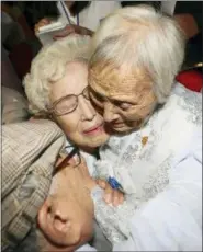  ?? LEE JI-EUN — YONHAP VIA AP ?? South Korean Cho Hye-do, 86, center, hugs her North Korean sister Cho Sun Do, 89, right, during the Separated Family Reunion Meeting at the Diamond Mountain resort in North Korea, Monday. Dozens of elderly South Koreans crossed the heavily fortified border into North Korea on Monday for heart-wrenching meetings with relatives.