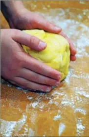  ?? PHOTO BY EMILY RYAN ?? A young helper kneads homemade pasta dough.