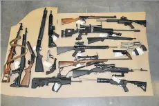  ?? COMBINED FORCES SPECIAL ENFORCEMEN­T UNIT ?? The 19 firearms seized by anti-gang police from Bryce McDonald’s Courtenay home in December 2013. Records show he had purchased 49 restricted firearms since 2009.