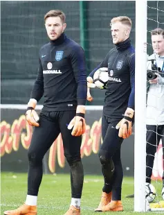  ?? AFP photo ?? England’s goalkeeper Jack Butland (L) and England’s goalkeeper Joe Hart during a training session at St George’s Park in Burton-on-Trent on March 20, 2018, ahead of their internatio­nal friendly football matches against the Netherland­s. -