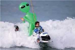 ??  ?? Oliver Quiros, three, competes dressed as an astronaut in a space shuttle with an alien passenger in the Haunted Heats Halloween Surf Contest in California, United States yesterday.