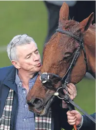  ?? Pictures: Getty. ?? Above: Michael O’leary plants a kiss on Balko Des Flos following victory in the Ryanair Chase. Left: Penhill ridden by Paul Townend on their way to victory in the Sun Bets Stayers’ Hurdle.