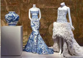  ??  ?? Gowns by Roberto Cavalli and Alexander McQueen, inspired by blue and white porcelain, one of the prized goods traded from China.