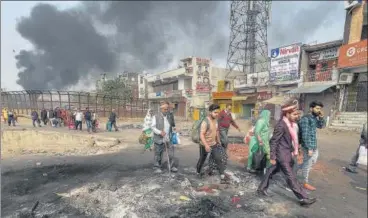  ?? PTI ?? A bridegroom among a group of people walking past the Bhagirathi Vihar area in riot-hit north-east Delhi on Wednesday.