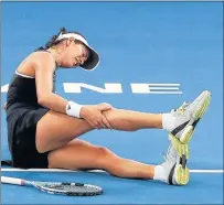  ?? Picture: AFP ?? DOWN AND OUT: Garbine Muguruza of Spain grabs her leg in pain before retiring from her match against Aleksandra Krunic of Serbia