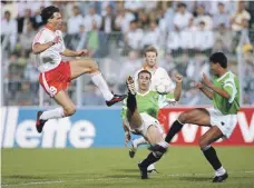  ?? Getty ?? Netherland­s player Marco van Basten takes on Egyptian Hossam Hassan in the 1990 World Cup game, which ended 1-1