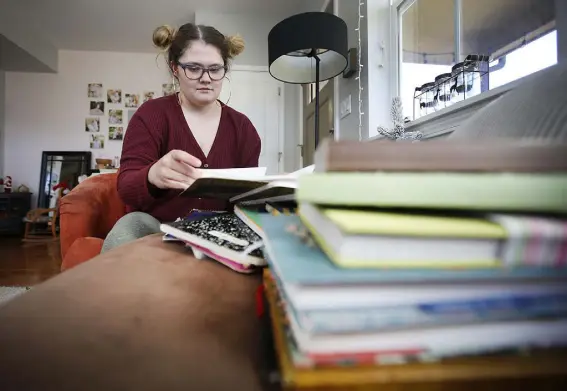  ?? Jerry Mcbride, The Durango Herald ?? Emma Harmon looks through some of her journals that she has kept over the years at her home in Durango.